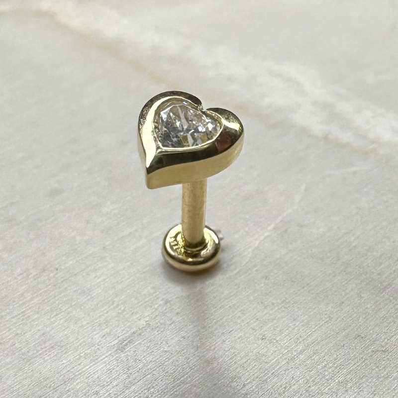 Yellow gold heart cartilage piercing with zircon