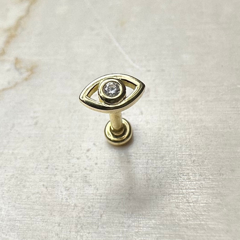 Yellow gold eye ear piercing with white zircons
