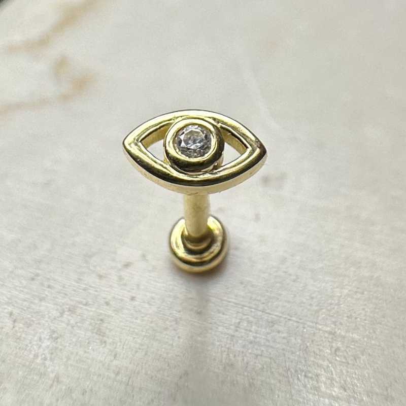 Yellow gold eye ear piercing with white zircons
