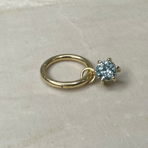 Yellow gold charm with clawed zirconium oxide