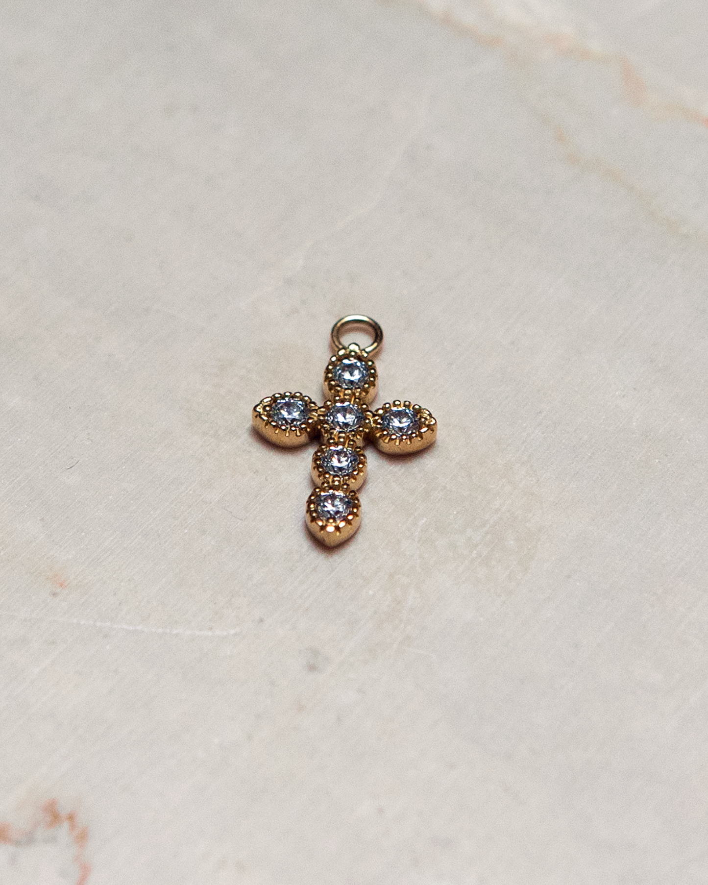 Yellow gold cross charm with white zirconium oxides