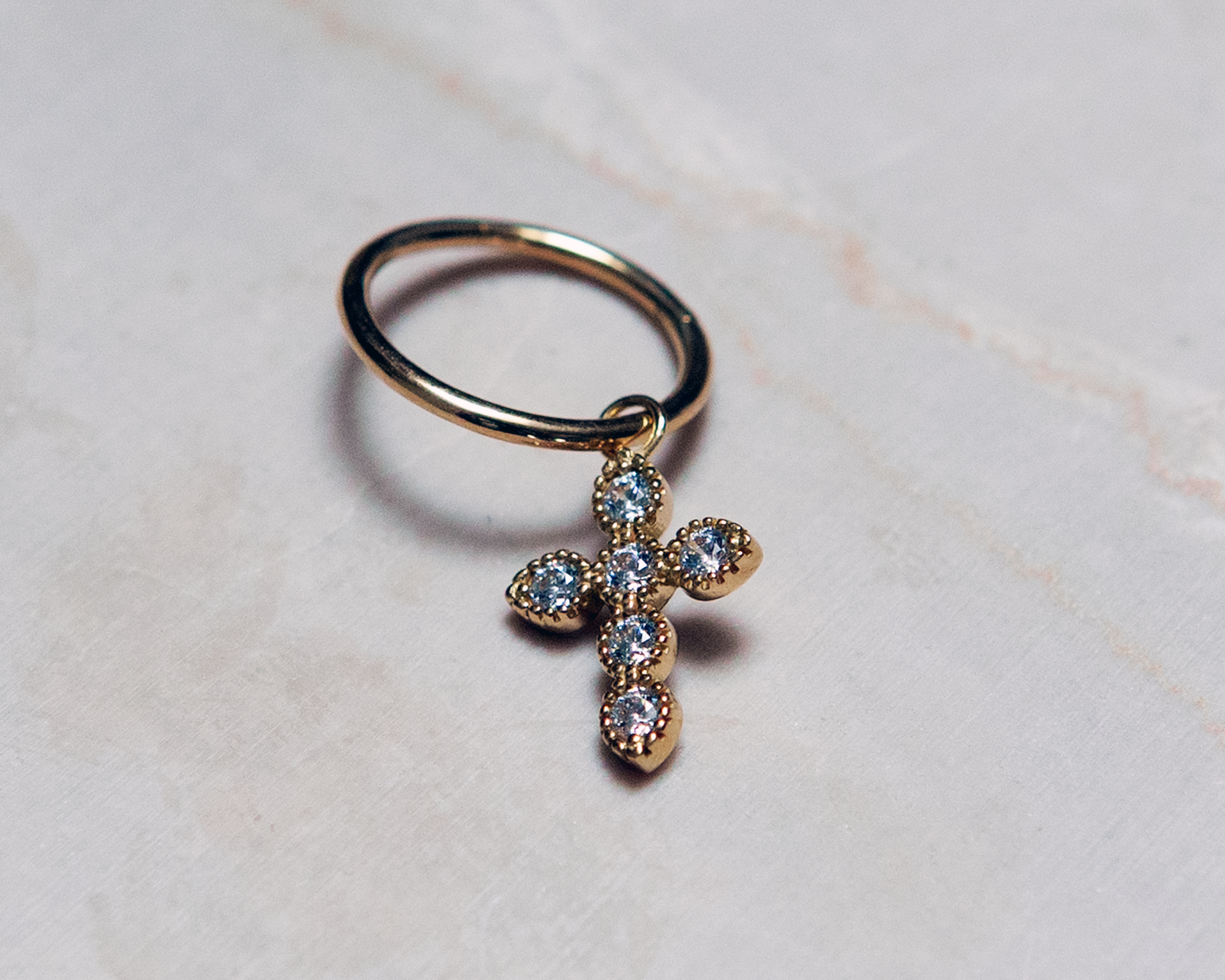 Yellow gold cross charm with white zirconium oxides
