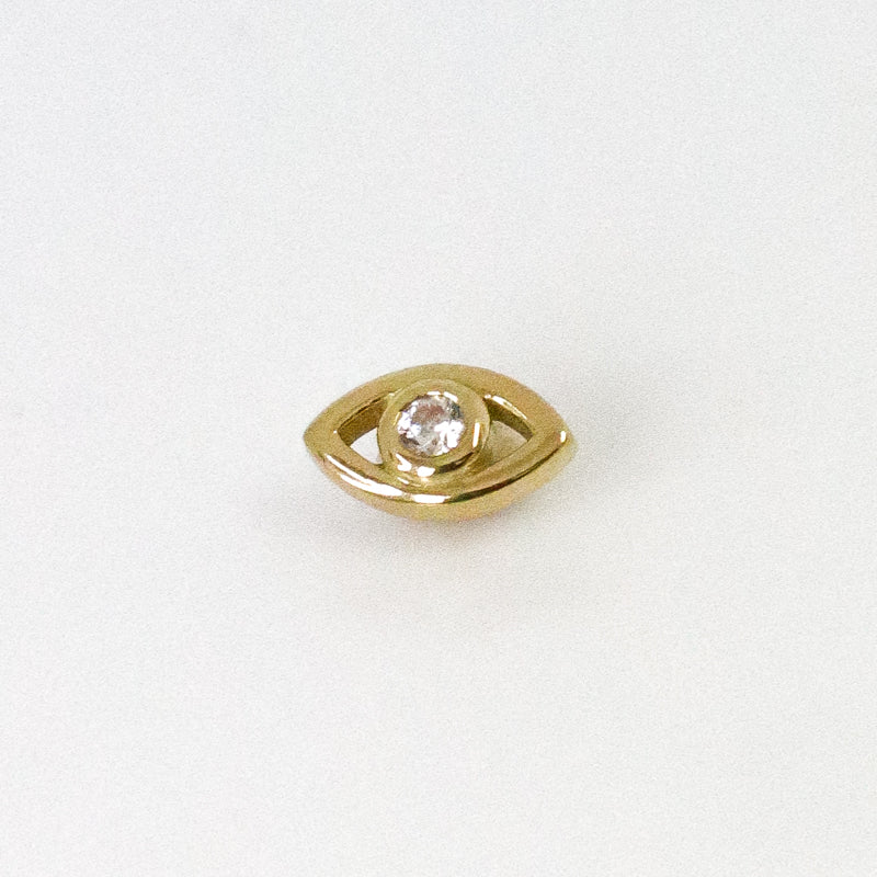 Yellow gold eye ear piercing with white zircons