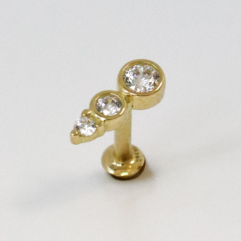 Yellow gold barrette helix piercing with three zircons
