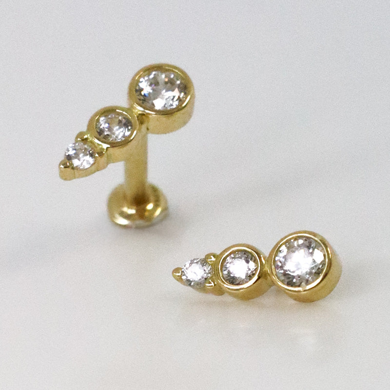 Yellow gold barrette helix piercing with three zircons