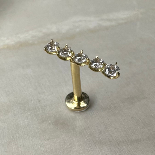 Yellow gold ear piercing with 5 zircon bar