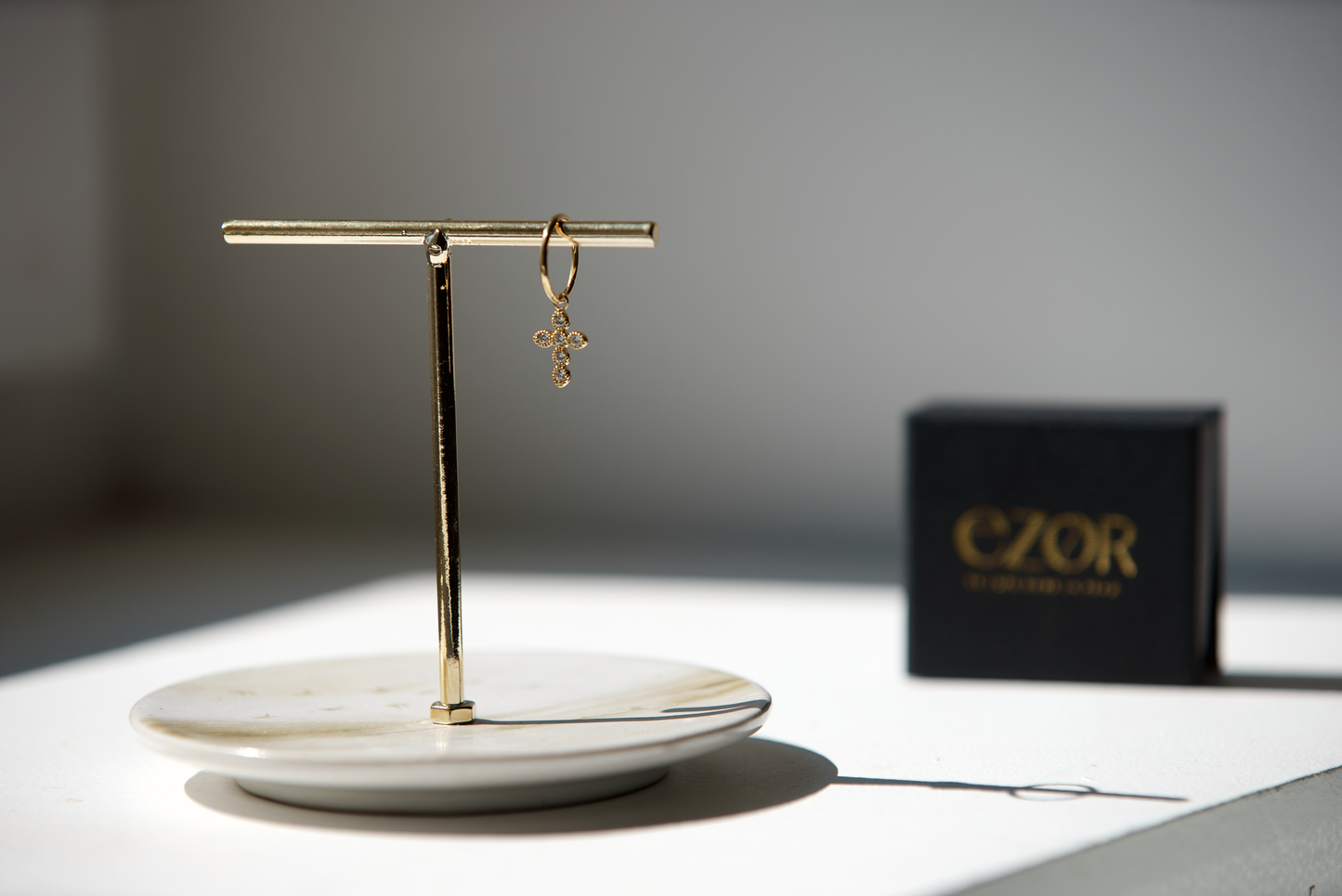 Yellow gold cross charm with white zirconium oxides