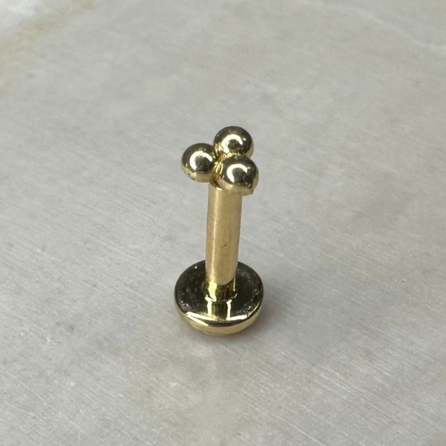 Yellow gold trinity piercing