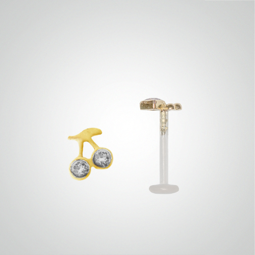 Cherry piercing with fuchsia zircons in yellow gold