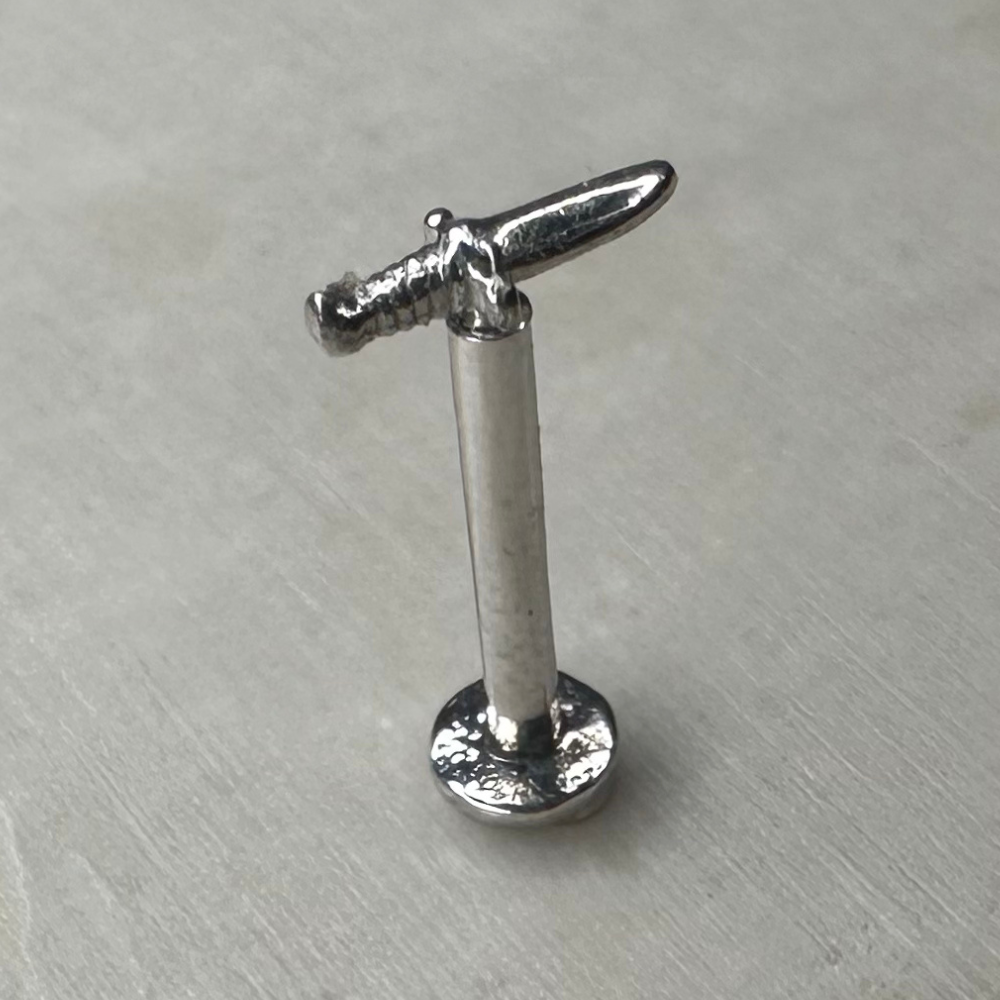 White gold dagger motif piercing