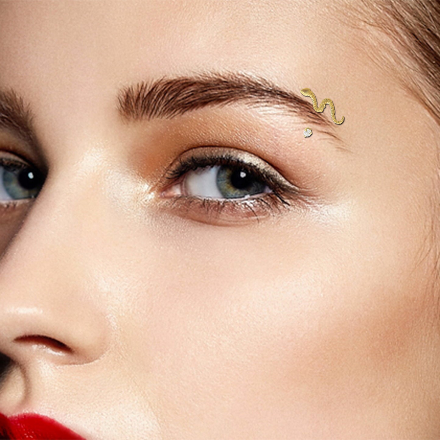 Yellow gold and zircon snake arch piercing