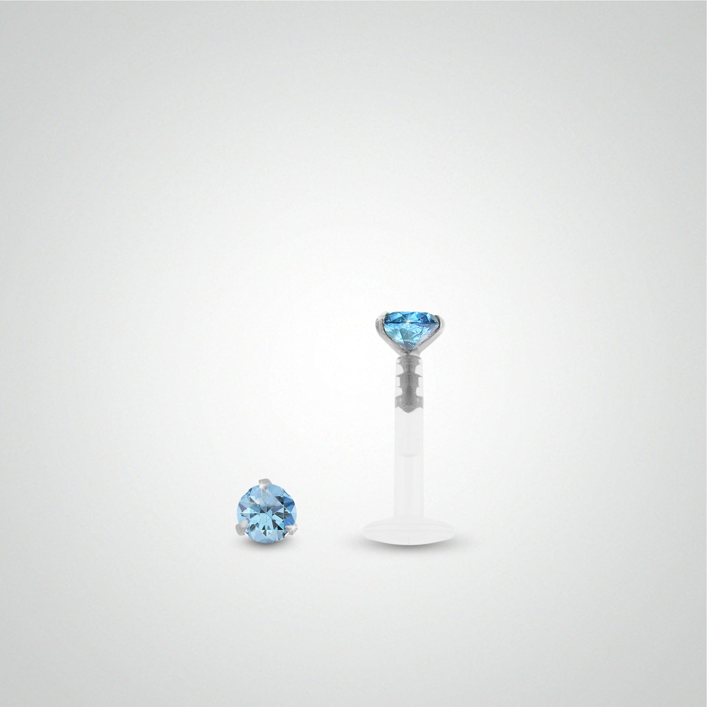 White gold conch piercing with light blue zirconium oxide