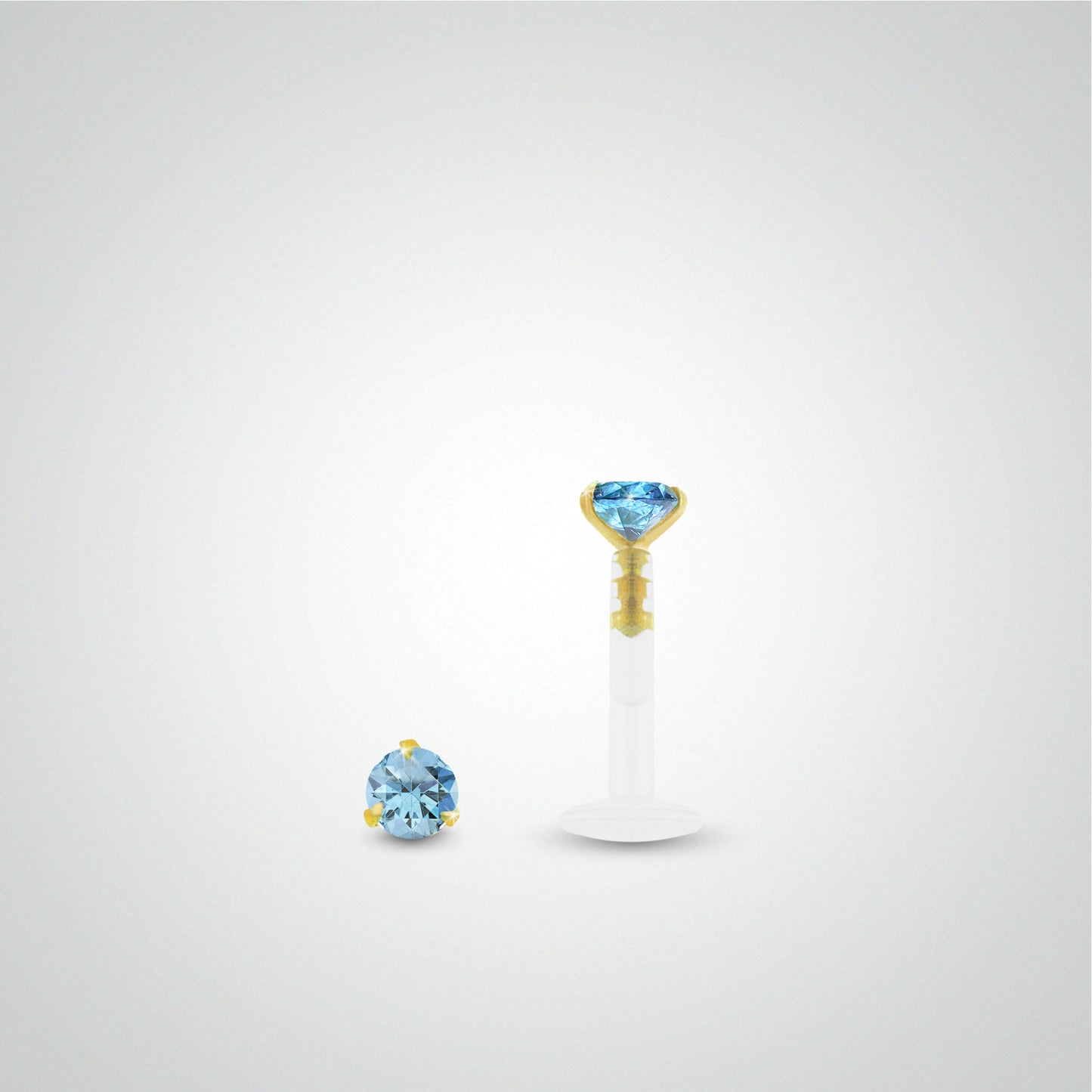 Yellow gold conch piercing with light blue zirconium oxide
