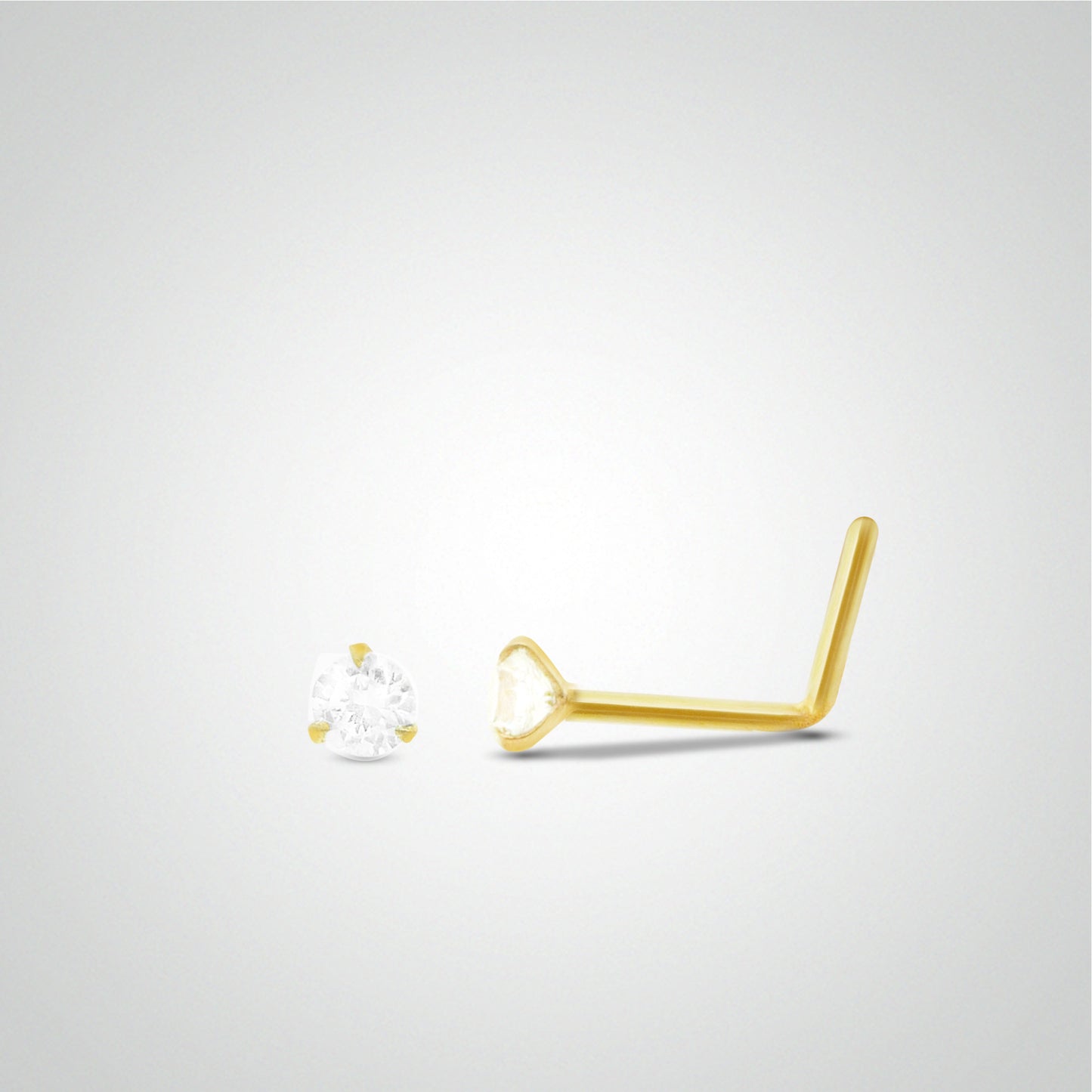 White zircon nose piercing with yellow gold