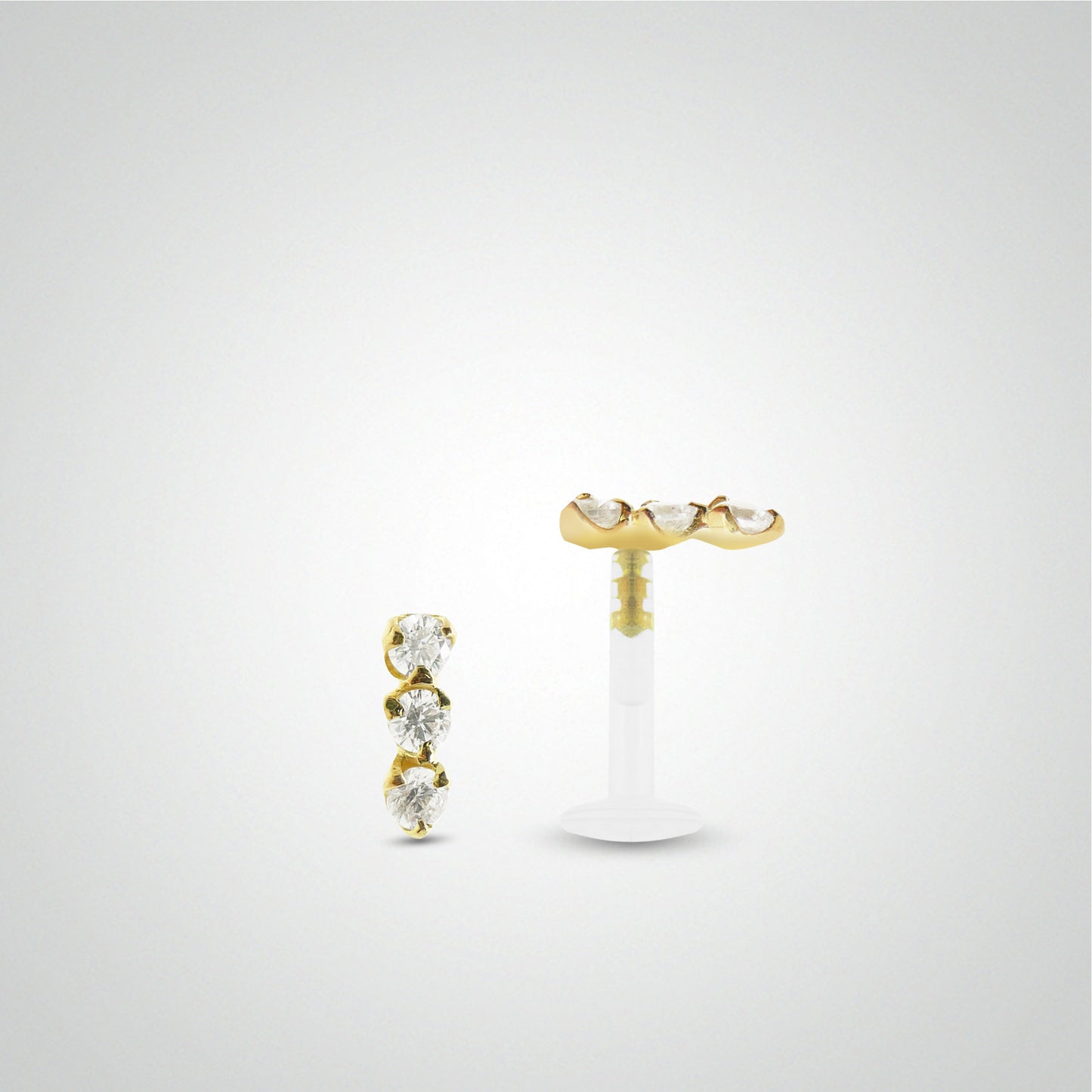 Yellow gold tragus piercing with three white zirconium oxides