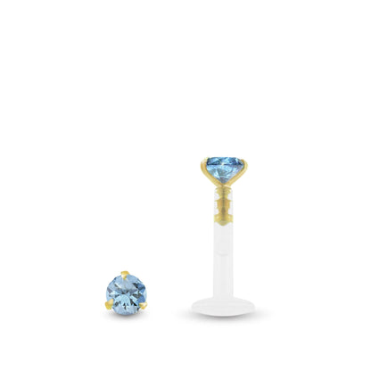Piercing conch en or jaune avec zircon bleu clair griffé et barre clipsable en Bioplast.