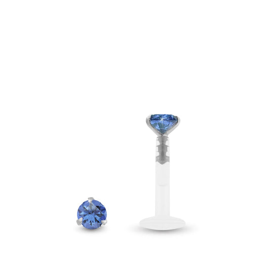 Piercing labret en or blanc avec zircon bleu foncé griffé sur une base en or blanc et barre en Bioplast.