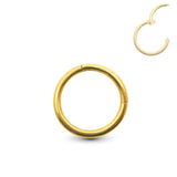 Yellow gold navel ring piercing