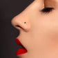 White gold nose piercing with three black zircons